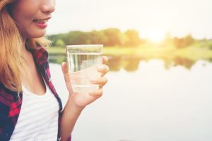 Young Beautiful Hipster Woman Holding Water Standing On